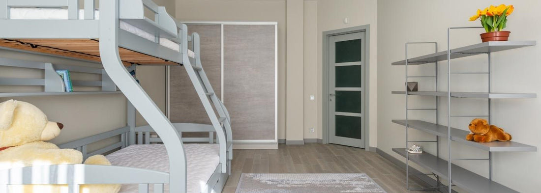 Grey triple bunk bed in a bedroom setting