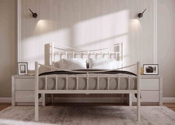 Front-on Belle Bed in light finish with decorative wrought iron detailing, robust steel tubing, and reinforced mesh bed base ready to support high loads