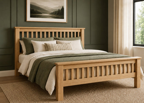 Amsterdam solid oak bed with slatted headboard and footboard, dressed with neutral and green bedding.
