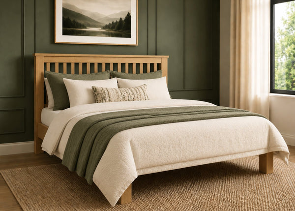 Amsterdam solid oak bed frame with slatted headboard and natural and green bedding.