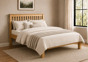 Barcelona LFE Bed: Natural pine low foot end bed with slatted headboard and cream bedding.
