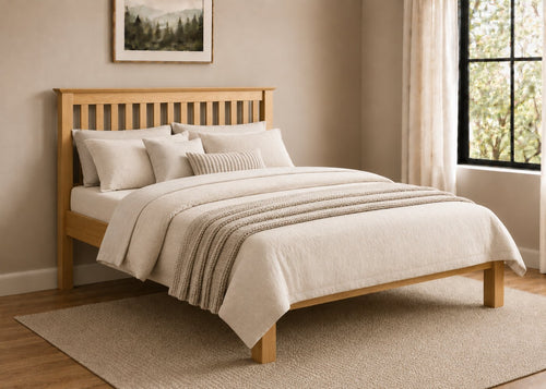 Barcelona LFE Bed: Natural pine low foot end bed with slatted headboard and cream bedding.