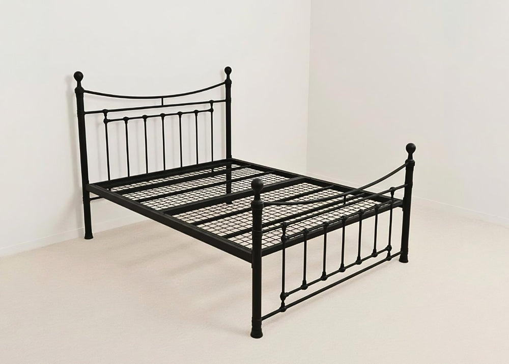 Black Calthorpe metal bed frame with decorative headboard, footboard, and reinforced mesh base.