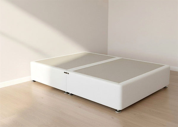 White upholstered heavy-duty divan base with non-slip grey top and chrome feet on a wooden floor.