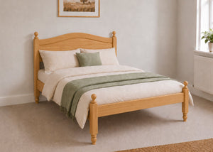 Dusseldorf Pine Bed frame with a natural finish, curved headboard, turned posts, and solid wooden slats in antique stain.