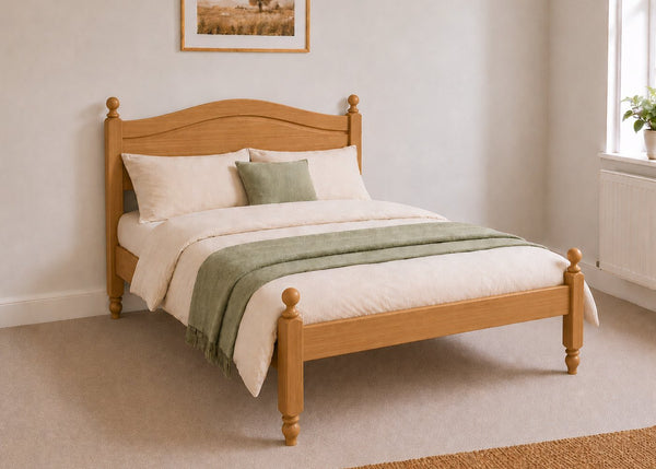 Dusseldorf Pine Bed frame with a natural finish, curved headboard, turned posts, and solid wooden slats in oak stain.
