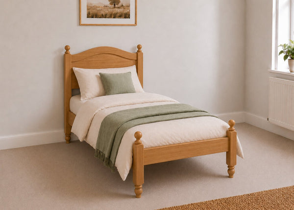 Dusseldorf Pine Bed frame with a natural finish, curved headboard, turned posts, and solid wooden slats in oak stain and single size.