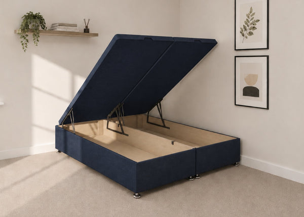 Navy blue fabric end lift ottoman bed with open storage base and reinforced gas pistons.