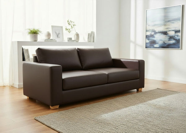 Angled view of Endura Sofa finished in Chocolate Vinyl