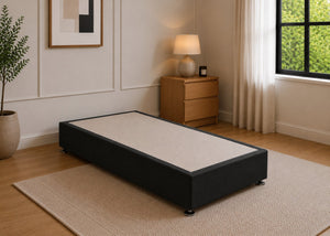 Single reinforced black upholstered divan base with non-slip top and silver feet.