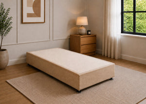 Single reinforced sand upholstered divan base with non-slip top and silver feet.
