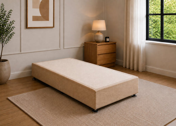 Single reinforced sand upholstered divan base with non-slip top and silver feet.