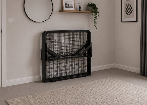 Black skid metal bed frame with reinforced mesh base and thick steel, folded for storage.