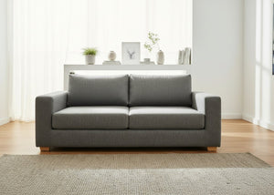 Grey sofa in a living room with a neutral color palette