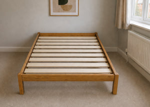 Lille Pine Bed: Low-profile natural pine wood bed frame with solid slats in a minimalist design.
