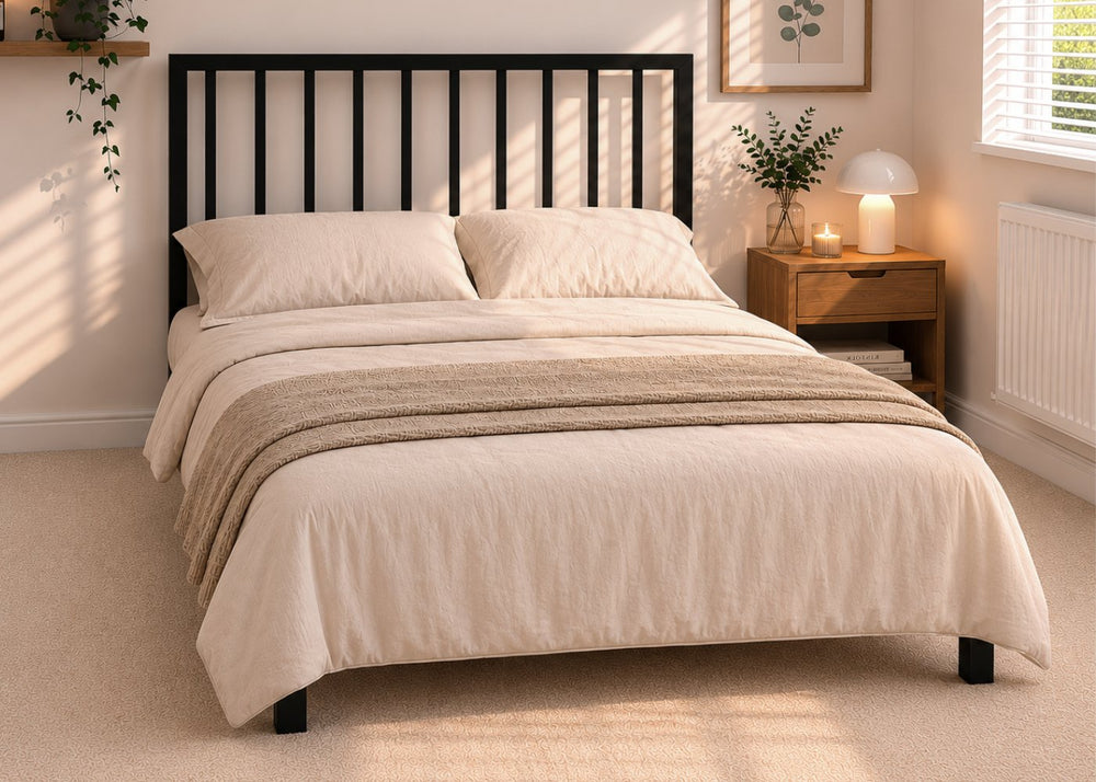 Mandy metal bed frame with vertical slat headboard and reinforced mesh base.