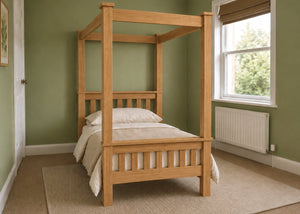 Regent natural wood four poster bed frame with thick square posts and slatted base in oak finish and single size.