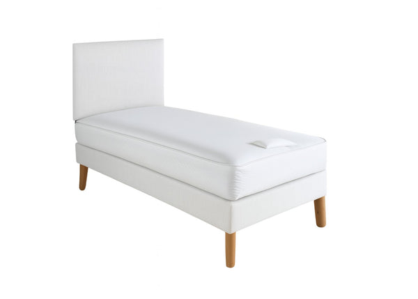 White upholstered shallow divan base with wooden legs and a matching headboard, topped with a white mattress.