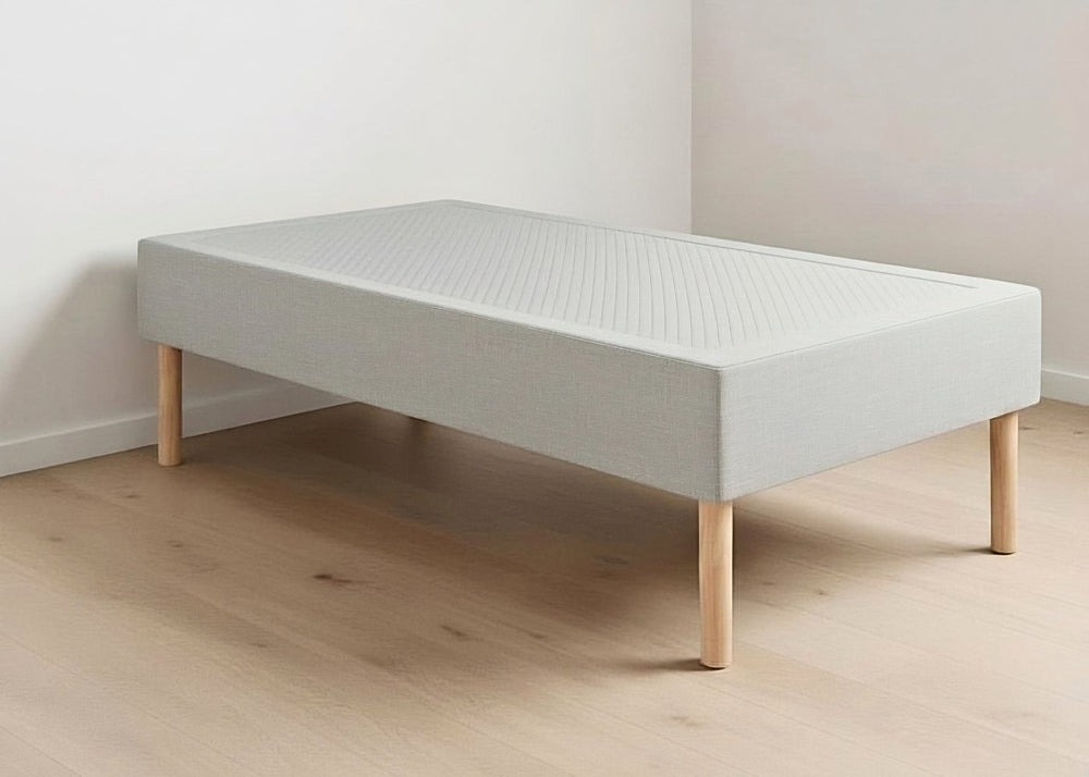 Grey linen upholstered shallow divan base with non-slip top, wooden legs, and matching headboard.