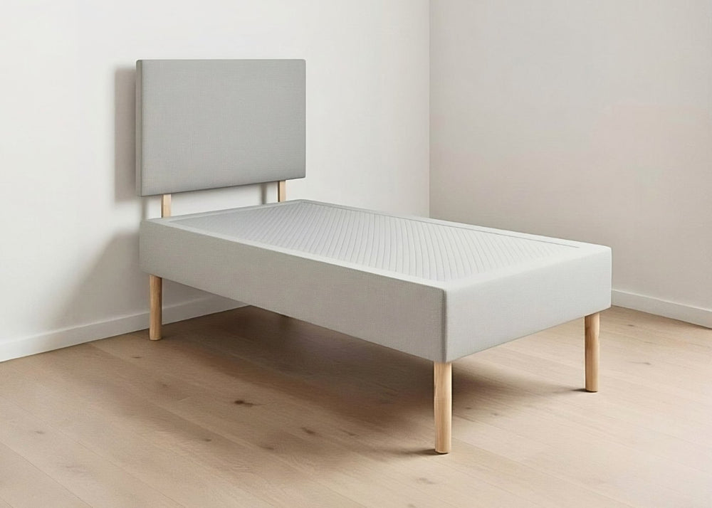 Grey linen upholstered shallow divan base with non-slip top, wooden legs, and matching headboard.