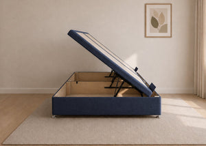 Navy fabric side lift ottoman bed with thick corner posts and reinforced storage base, open to show gas-assisted mechanism.