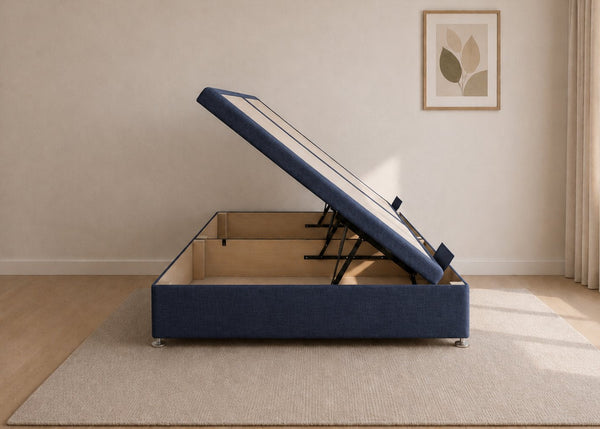 Navy fabric side lift ottoman bed with thick corner posts and reinforced storage base, open to show gas-assisted mechanism.
