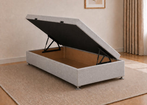 Single grey fabric side lift ottoman bed with thick corner posts and reinforced storage base, open to show gas-assisted mechanism.