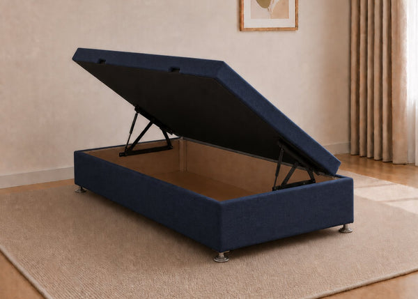 Single navy fabric side lift ottoman bed with thick corner posts and reinforced storage base, open to show gas-assisted mechanism.