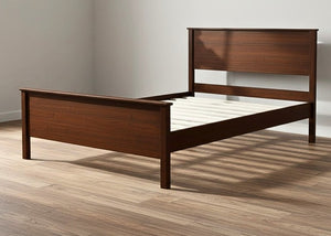 Stavern Pine Bed: Dark brown solid pine bed frame with a slatted headboard and footboard, featuring white wooden slats.