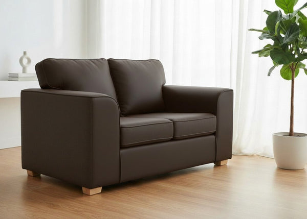 Titan Sofa finished in Chocolate Brown Vinyl with light wood feet in a lifestyle angle
