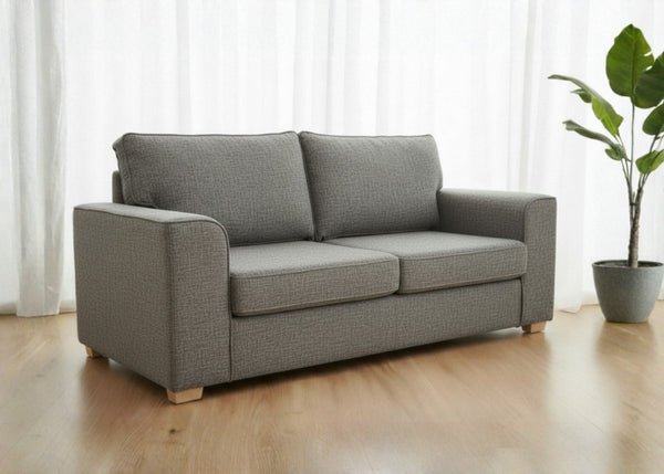Titan sofa finished in Dandy grey fabric shown in a lifestyle angle