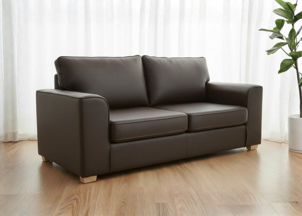 Titan sofa finished in brown vinyl shown in a lifestyle angle