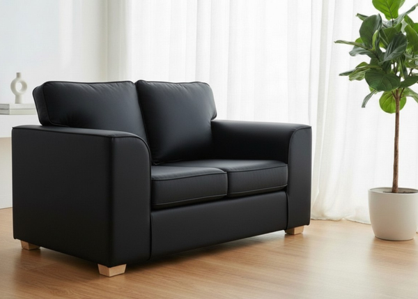 Titan Sofa finished in Black Vinyl with light wood feet in a lifestyle angle