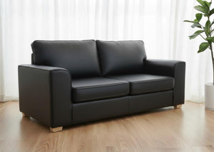 Angled view of Titan sofa finished in Black vinyl shown with light wood feet