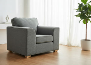 Angled view of Titan Chair Finished in Dandy Grey fabric with light wood feet