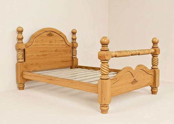 Warsaw Pine Bed, a solid Scandinavian pine bed frame with turned posts, carved headboard, and supportive slats.