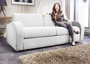 Retro 3 Seater Sofa Bed in Stone with Lady Sittong on it